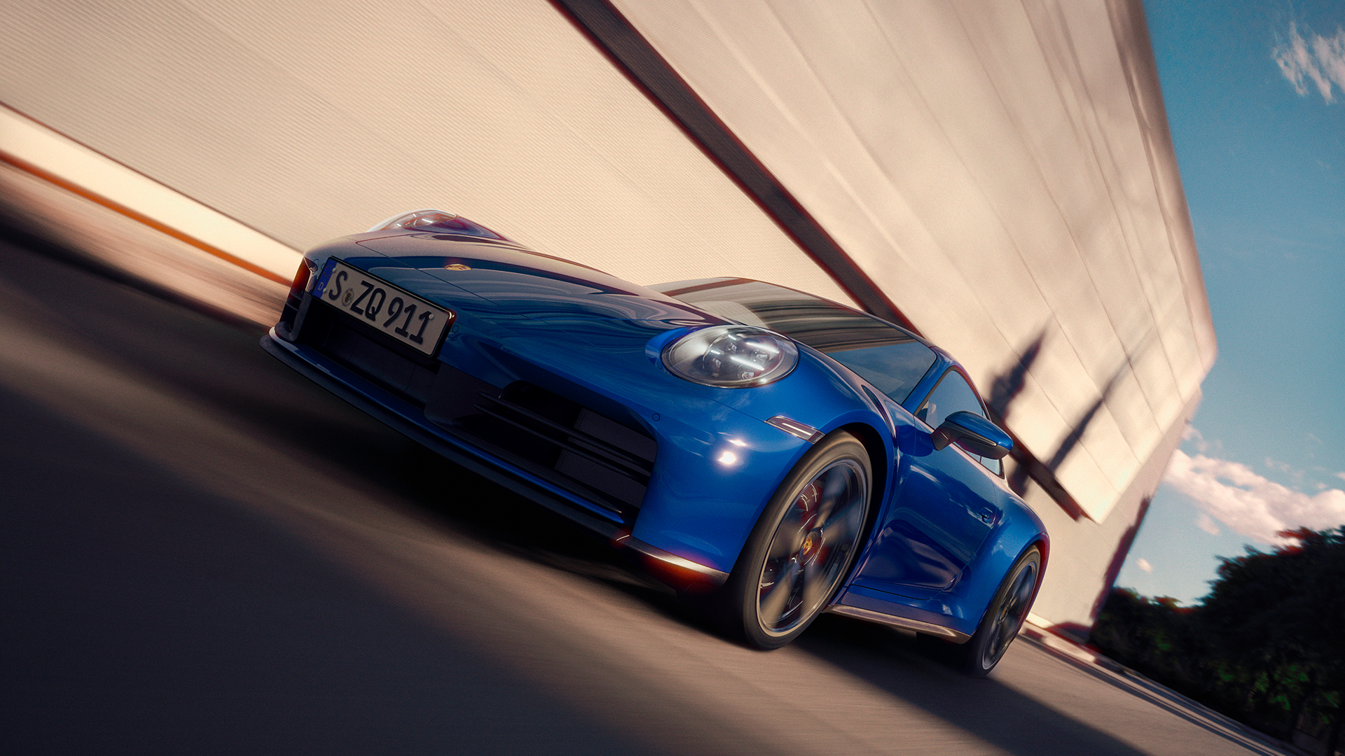 Ikoninen, sininen Porsche 911 ajossa maantiellä.